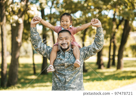 Officer spending time with his daughter and looking happy and excited Officer spending time with his daughter and looking happy and excited 97478721