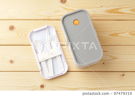 New empty plastic lunch box on a wooden background New empty plastic lunch box on a wooden background 97479319