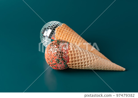 Christmas fun decorative fake ice cream cone on dark green background 97479382