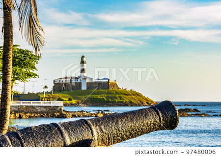 Old cannon and the Barra Lighthouse in the city of Salvador in Bahia surrounded by the sea Old cannon and the Barra Lighthouse in the city of Salvador in Bahia surrounded by the sea 97480006