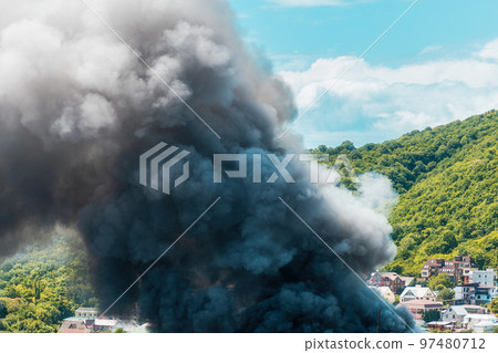 Fire in the village. Closeup of clouds of black smoke. The concept of an emergency, disaster and insurance 97480712