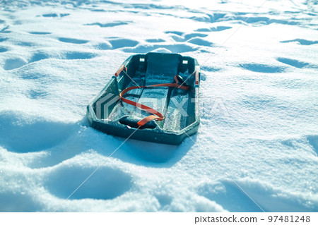 Winter sled in the snow in the winter park Winter sled in the snow in the winter park 97481248