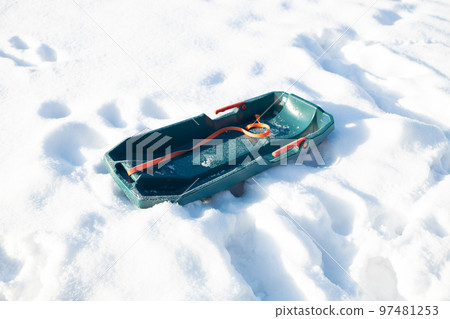 Winter sled in the snow in the winter park Winter sled in the snow in the winter park 97481253