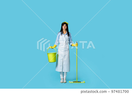 woman in rubber gloves and cleaner apron with cleaning supplies 97481700
