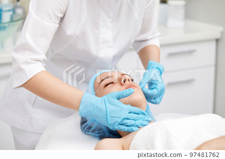 young beautiful woman receiving facial massage. spa young beautiful woman receiving facial massage. spa 97481762