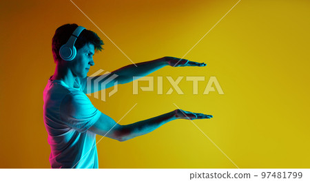 Young man listening to music with headphones 97481799