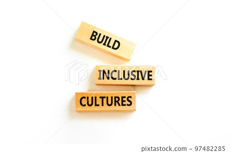 Build inclusive cultures symbol. Concept words Build inclusive cultures on wooden blocks. Beautiful white table white background. Business build inclusive cultures concept. Copy space. 97482285