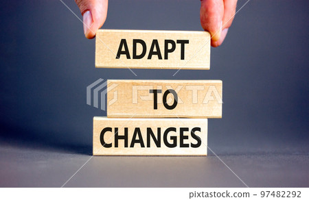 Adapt to changes symbol. Concept words Adapt to changes on wooden blocks. Businessman hand. Beautiful grey table grey background. Business and Adapt to changes quote concept. Copy space. Adapt to changes symbol. Concept words Adapt to changes on wooden blocks. Businessman hand. Beautiful grey table grey background. Business and Adapt to changes quote concept. Copy space. 97482292
