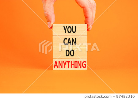 You can do anything symbol. Concept word You can do anything on wooden blocks. Businessman hand. Beautiful orange table orange background. Business and you can do anything concept. Copy space. You can do anything symbol. Concept word You can do anything on wooden blocks. Businessman hand. Beautiful orange table orange background. Business and you can do anything concept. Copy space. 97482310