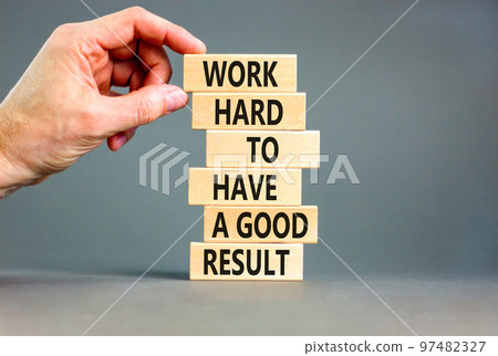 Work hard for result symbol. Concept words Work hard to have a good result on wooden blocks on a beautiful grey table grey background. Businessman hand. Business work hard for good result concept. Work hard for result symbol. Concept words Work hard to have a good result on wooden blocks on a beautiful grey table grey background. Businessman hand. Business work hard for good result concept. 97482327