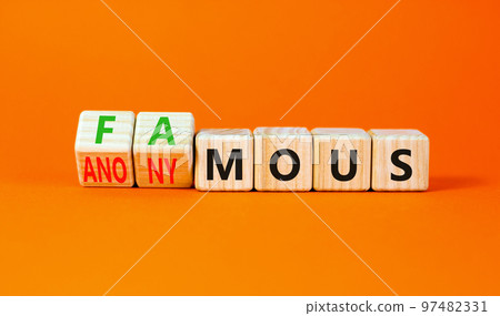 Famous or anonymous symbol. Concept word Famous and Anonymous on wooden cubes. Beautiful orange table orange background. Business famous or anonymous concept. Copy space. Famous or anonymous symbol. Concept word Famous and Anonymous on wooden cubes. Beautiful orange table orange background. Business famous or anonymous concept. Copy space. 97482331