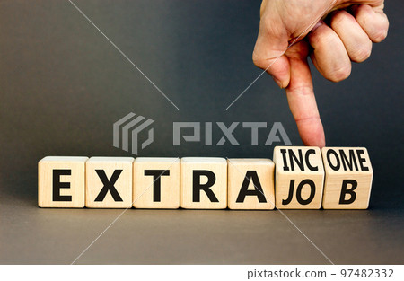 Extra job and income symbol. Concept words Extra job Extra income on wooden cubes. Businessman hand. Beautiful grey table grey background. Business extra job and income concept. Copy space. Extra job and income symbol. Concept words Extra job Extra income on wooden cubes. Businessman hand. Beautiful grey table grey background. Business extra job and income concept. Copy space. 97482332