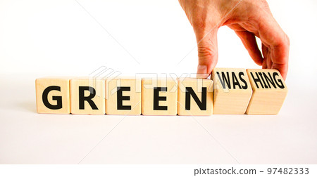 Green or greenwashing symbol. Concept words Green and Greenwashing on wooden cubes. Businessman hand. Beautiful white table white background. Business green greenwashing concept. Copy space. Green or greenwashing symbol. Concept words Green and Greenwashing on wooden cubes. Businessman hand. Beautiful white table white background. Business green greenwashing concept. Copy space. 97482333