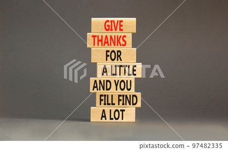 Give thanks symbol. Concept words Give thanks for a little and you will find a lot on wooden blocks. Beautiful grey background copy space. Business motivational give thanks concept Give thanks symbol. Concept words Give thanks for a little and you will find a lot on wooden blocks. Beautiful grey background copy space. Business motivational give thanks concept 97482335
