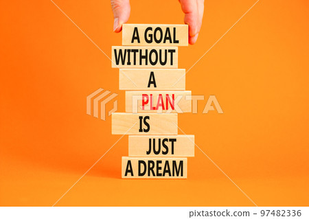 Goal and plan symbol. Concept words A goal without a plan is just a dream on wooden blocks. Beautiful orange background copy space. Businessman hand. Business plan motivational goal or dream concept. Goal and plan symbol. Concept words A goal without a plan is just a dream on wooden blocks. Beautiful orange background copy space. Businessman hand. Business plan motivational goal or dream concept. 97482336
