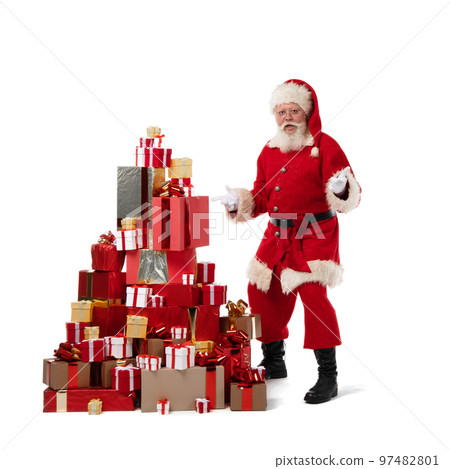 Santa Claus with pile of Christmas gifts 97482801