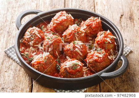 Polpette meatballs with parmesan stewed in a rich tomato sauce close-up in a frying pan. Horizontal 97482908