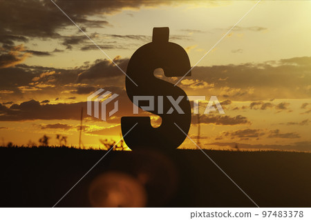 Dollar money sign at sunset in the rays of the setting sun. Sunset currency. Devaluation of money. Dollar money sign at sunset in the rays of the setting sun. Sunset currency. Devaluation of money. 97483378