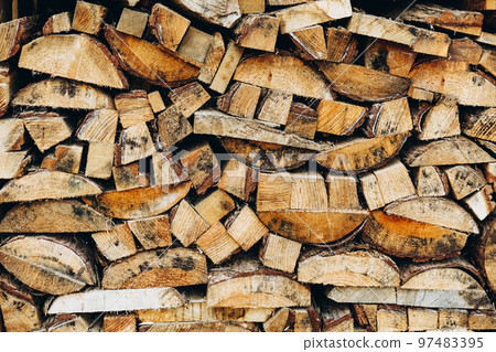 Many wooden logs stacked in a row Many wooden logs stacked in a row 97483395