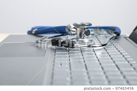 Stethoscope on laptop. Telemedicine, telehealth concept. Online video diagnostics. Using electronic communications and software for treatment. 97483456
