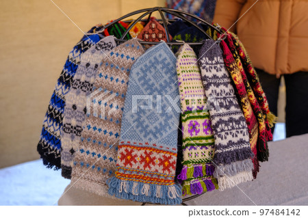 knitted warm gloves for winter in different colors. handicraft knitted warm gloves for winter in different colors. handicraft 97484142