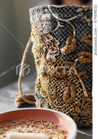 bag of precious stones sits on table, soft selective focus. bead embroidery, hobby design bag of precious stones sits on table, soft selective focus. bead embroidery, hobby design 97484632