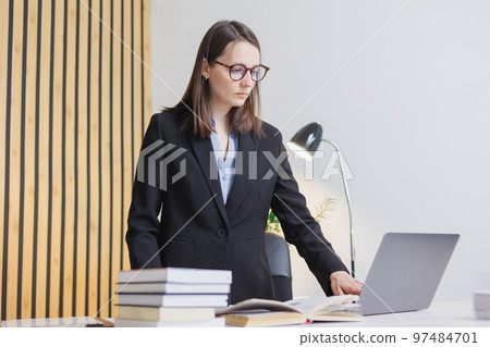 business woman is working on laptop in office, job with papers. confident business lady 97484701