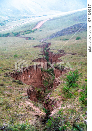 a large crack in the ground after seismic activity 97484917