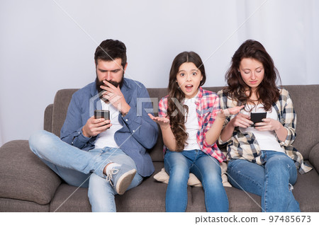 Stop ignoring kid. Parenthood failure. Ignored baby. Offended feelings. Stuck in online. Ignored child. Busy parents surfing internet smartphones. Dad and mom ignoring daughter needs. Bad habits 97485673