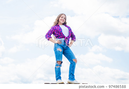 Loving her new style. enjoy good weather forecast. girl wearing casual style clothes. spring fashion wear. happy kid on sky background. cheerful retro girl. child having fun. happy childhood 97486588