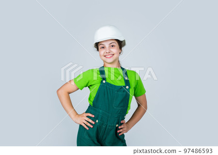 Assistant. Portrait of little girl with hard hat. Little girl in hard hat play in workshop. Child protection and safety. Little smiling builder in helmet. happy childhood. career guidance idea Assistant. Portrait of little girl with hard hat. Little girl in hard hat play in workshop. Child protection and safety. Little smiling builder in helmet. happy childhood. career guidance idea 97486593