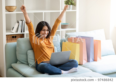 Online Sales. Joyful Arab Woman Celebrating Success With Laptop 97486842
