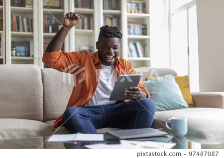 African american plump guy student passing test online 97487087
