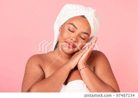 Beauty sleep concept. Portrait of black body positive lady napping, pretending sleeping over pink studio background Beauty sleep concept. Portrait of black body positive lady napping, pretending sleeping over pink studio background 97487134