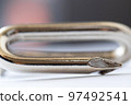Art background, single metal nail with a bend out of focus. Perfectly bokeh effect, macro. 97492541