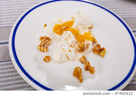 Fresh cottage cheese with honey and walnuts Fresh cottage cheese with honey and walnuts 97492612