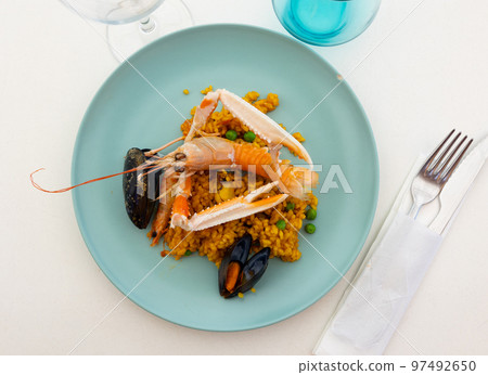 Just cooked paella de marisco on table Just cooked paella de marisco on table 97492650