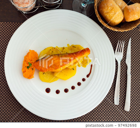 Salmon with potato and sweet potato puree Salmon with potato and sweet potato puree 97492698