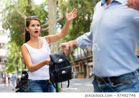 Street robbery pulling woman backpack Street robbery pulling woman backpack 97492746