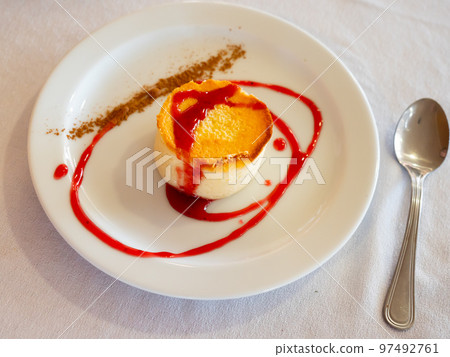 Yummy round cheesecake served with strawberry jam served with coffee in a cafe Yummy round cheesecake served with strawberry jam served with coffee in a cafe 97492761
