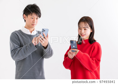Man and woman looking at mobile phone Man and woman looking at mobile phone 97493841