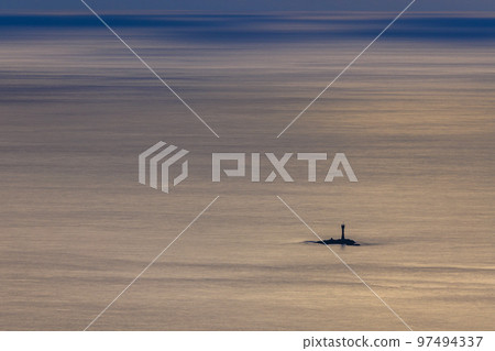 A lighthouse floating in a calm sea like a sea of clouds 97494337