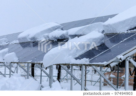 Snow-covered solar panels power generation snow country winter 97494903