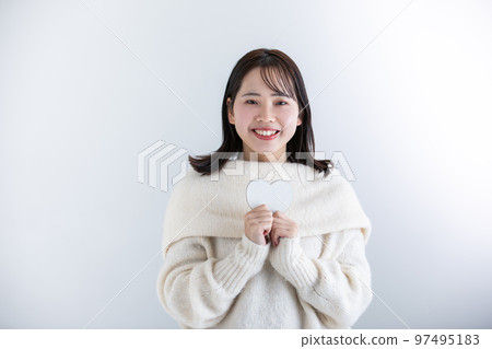 A woman wearing a white knit, winter 97495183