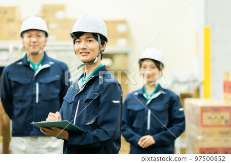 A worker who checks inventory in a warehouse A worker who checks inventory in a warehouse 97500852