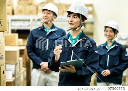 A worker who checks inventory in a warehouse A worker who checks inventory in a warehouse 97500853