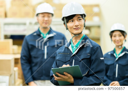 A worker who checks inventory in a warehouse 97500857