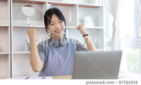 Joyful, Surprised or shocked Asian woman raised her arms all the way because she did a good job the boss gave her a big bonus making her very happy, Raise your hand, Smiling and screaming for success. Joyful, Surprised or shocked Asian woman raised her arms all the way because she did a good job the boss gave her a big bonus making her very happy, Raise your hand, Smiling and screaming for success. 97502838