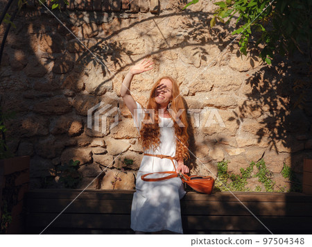 Happy woman tourist on blooming street of Antalya 97504348
