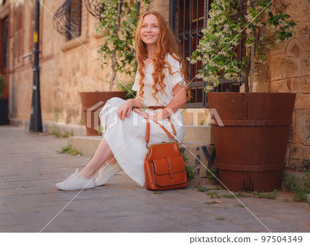 Happy woman tourist on blooming street of Antalya 97504349